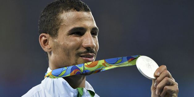2016 Rio Olympics - Athletics - Victory Ceremony - Men's 1500m Victory Ceremony - Olympic Stadium - Rio de Janeiro, Brazil - 20/08/2016. Taoufik Makhloufi (ALG) of Algeria poses with his silver medal. REUTERS/Dylan Martinez FOR EDITORIAL USE ONLY. NOT FOR SALE FOR MARKETING OR ADVERTISING CAMPAIGNS.
