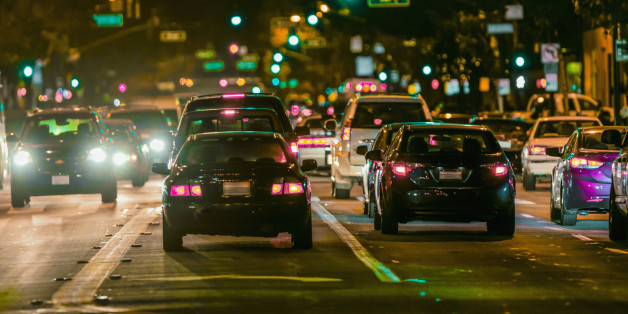 Cars driving in city traffic at night