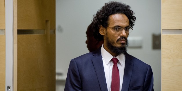 Alleged Al-Qaeda-linked Islamist leader Ahmad Faqi Al Mahdi arrives in the courtroom of the International Criminal Court (ICC) on September 30, 2015, in The Hague. Ahmad Al Faqi Al Mahdi was transferred to the ICC on September 26 following an arrest warrant issued by the Court on September 18 facing charges of ordering the destruction of monuments in Mali's fabled city of Timbuktu. AFP PHOTO / ANP POOL / ROBIN VAN LONKHUIJSEM ==NETHERLANDS OUT== (Photo credit should read ROBIN VAN LONKH