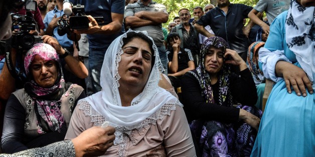 TOPSHOT - Women cry during a funeral for a victim of last night's attack on a wedding party that left 50 dead in Gaziantep in southeastern Turkey near the Syrian border on August 21, 2016.
At least 50 people were killed when a suspected suicide bomber linked to Islamic State jihadists attacked a wedding thronged with guests, officials said on August 21. Turkish President Recep Tayyip Erdogan said the IS extremist group was the 'likely perpetrator' of the bomb attack, the deadliest in 2016, in Gaziantep late Saturday that targeted a celebration attended by many Kurds.
/ AFP / ILYAS AKENGIN (Photo credit should read ILYAS AKENGIN/AFP/Getty Images)