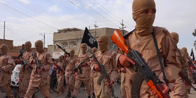 FILE -- In this photo released on April 25, 2015 by a militant website, which has been verified and is consistent with other AP reporting, young boys known as the "lion cubs" hold rifles during a parade after graduating from a religious school in Tal Afar, near Mosul, northern Iraq. The suicide attacker who detonated his explosives amid an outdoor Kurdish wedding party in southeastern Turkey, killing at least 51 people, Saturday, Aug. 20, 2016, was an Islamic State group child as young as 12 yea
