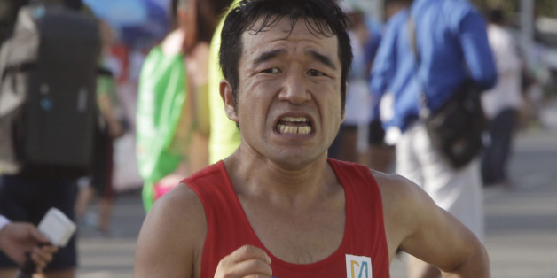 Japanese-Cambodian entertainer Neko Hiroshi, whose real name is Kuniaki Takizaki, approaches the finish line to win the International Half Marathon in Phnom Penh, Cambodia, Sunday, June 12, 2016. Several thousands of Cambodians and foreigners took part in the race marking the birthday of Queen Monineath Sihanouk on June 18. Takizaki, who is from Japan but switched to Cambodian nationality in 2011, was chosen to represent the country at the 2016 Olympics in Rio de Janeiro, Brazil, in August after