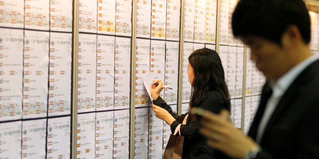 Job seekers look at help-wanted advertisements at a job fair in Seoul September 21, 2011. REUTERS/Lee Jae-Won/File Photo GLOBAL BUSINESS WEEK AHEAD PACKAGE - SEARCH "BUSINESS WEEK AHEAD JULY 11" FOR ALL IMAGES