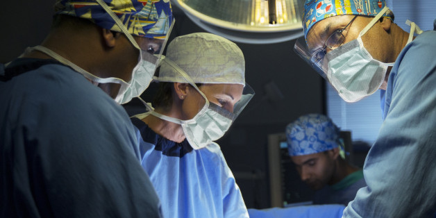Surgeons performing surgery in operating room