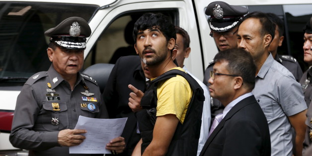 A suspect of the August 17 Bangkok blast who was arrested last week near the border with Cambodia takes part in a crime re-enactment near the bomb site at Erawan Shrine in Bangkok, Thailand, September 9, 2015. REUTERS/Jorge Silva