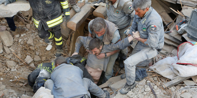 A man is rescued alive from the ruins following an earthquake in Amatrice, central Italy, August 24, 2016. REUTERS/Remo Casilli