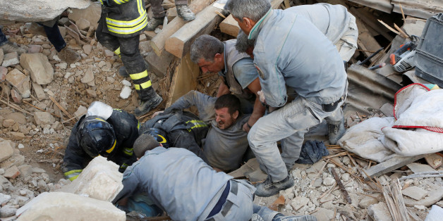 A man is rescued alive from the ruins following an earthquake in Amatrice, central Italy, August 24, 2016. REUTERS/Remo Casilli TPX IMAGES OF THE DAY