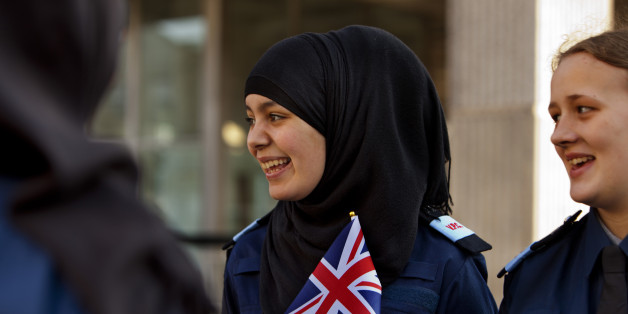 Volunteer Police Cadets with Union jack flags watching an army parade through Hammersmith, London. The Volunteer Police Cadets (VPC) is an uniformed voluntary youth organisation, supported by The Metropolitan Police Service, open to young people aged between 14 -19 from across London's diverse communities On 11/3/2012 some 150 troops from the Territorial Army regiment The Royal Yeomanry marching through the streets of Hammersmith accompanied by their Guidons (Colours), the Regimental Band of the Royal Yeomanry, and four tracked vehicles. The parades ended at a reception hosted by the Mayor & held at the town hall to honour the bravery and safe return from operations of members of the Regiment. (Photo by In Pictures Ltd./Corbis via Getty Images)