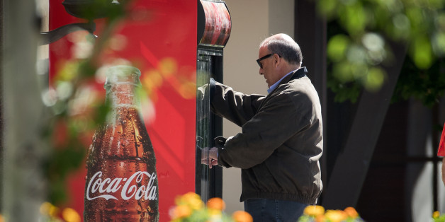 SUN VALLEY, ID - JULY 6: Ahmet Muhtar Kent, chief executive officer of The Coca-Cola Company, gets a soda out of Coke branded refrigerator as he attends the annual Allen & Company Sun Valley Conference, July 6, 2016 in Sun Valley, Idaho. Every July, some of the world's most wealthy and powerful businesspeople from the media, finance, technology and political spheres converge at the Sun Valley Resort for the exclusive weeklong conference. (Photo by Drew Angerer/Getty Images)