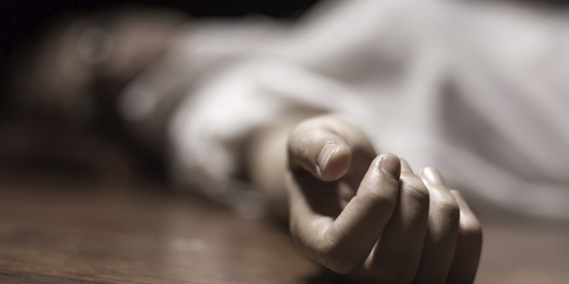 The dead woman's body. Focus on hand