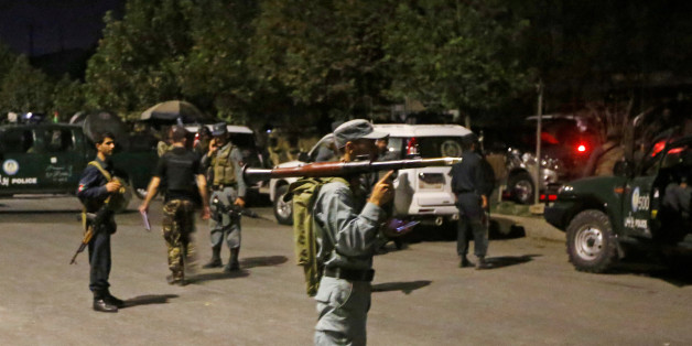 Afghan policemen stand guard at the site of an attack at American University of Afghanistan in Kabul, Afghanistan August 24, 2016. REUTERS/Omar Sobhani