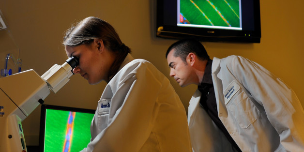 WASHINGTON DC-FEBRUARY 12: Studying genes related to athletics are L to R: Human Science major Ashley Huber looks at muscle tissue with her instructor J.P. Hyatt asst. professor of Human Science at Georgetown University in Washington DC February 12, 2010. (Photo by John McDonnell/The Washington Post via Getty Images)