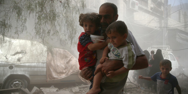 Residents flee a site after an air strike on the rebel-held besieged town of Douma, eastern Damascus suburb of Ghouta, Syria August 20, 2016. REUTERS/Bassam Khabieh