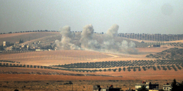 Smokes billow in Syrian side, pictured from Karkamis, Turkey, Wednesday, Aug. 24, 2016. Turkey's military and the U.S.-backed coalition forces on Wednesday launched an operation to clear a Syrian border town from Islamic State militants, Turkey's prime minister's office said. The state-run Anadolu Agency said the operation, which began hours after Turkey indicated it would step up its engagement in Syria, began at 4 a.m. with Turkish artillery launching intense fire on Jarablus from the Turkish town of Karkamis, followed by Turkish warplanes bombing IS targets in the town.(DHA via AP)