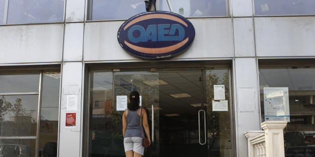 A woman stands outside a Greek Manpower Employment Organisation (OAED) office in a northern suburb of Athens September 12, 2013. Greece's jobless rate rose to 27.9 percent in June from 27.6 percent in May, reflecting the impact of a six-year, austerity-fuelled recession, the country's statistics service ELSTAT said on Thursday. REUTERS/John Kolesidis (GREECE - Tags: POLITICS BUSINESS EMPLOYMENT)