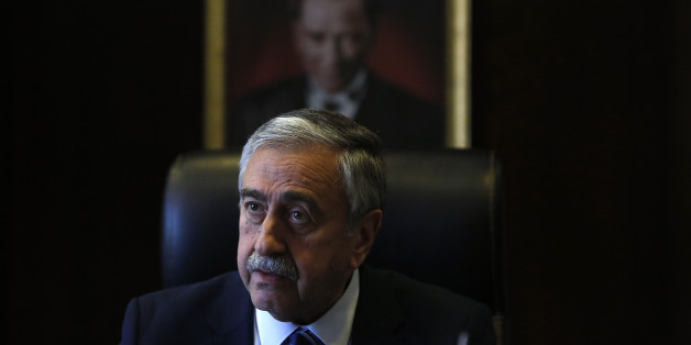 Turkish Cypriot leader Mustafa Akinci is seen at his office in front of the portrait of the Turkish Republic founder Kemal Ataturk, during an interview for the Associated Press in the Turkish breakaway north part of the divided capital Nicosia in this ethnically Mediterranean island of Cyprus, Monday, April 4, 2016. The leader of the breakaway Turkish Cypriots says the ethnically divided islandâs potential wealth from newly found offshore gas deposits could partly pay for a costly reunification deal. (AP Photo/Petros Karadjias)
