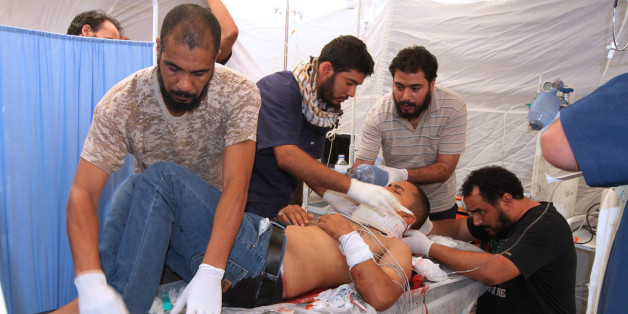 A fighter from Libyan forces allied with the U.N.-backed government, who was injured during a battle with Islamic State fighters, is treated at a field hospital in Sirte, Libya August 27, 2016. REUTERS/Hani Amara