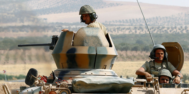 Turkish soldiers on an armoured personnel carrier escort a military convoy on a main road in Karkamis on the Turkish-Syrian border in the southeastern Gaziantep province, Turkey, August 26, 2016. REUTERS/Umit Bektas