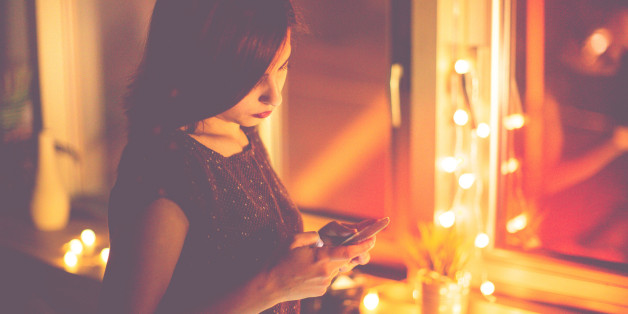 Cute girl using phone, indoors