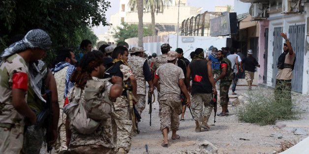 Members of the forces loyal to Libya's UN-backed Government of National Accord (GNA) walk toward their position in the coastal city of Sirte, east of the capital Tripoli, prior to their military operation to clear the Islamic State group's (IS) jihadists from the city on August 28, 2016.GNA forces who for more than three months have been pressing an offensive to retake Sirte from IS, pushed into the last areas of the city held by the group in what was the jihadists' coastal stronghold. / AFP / M