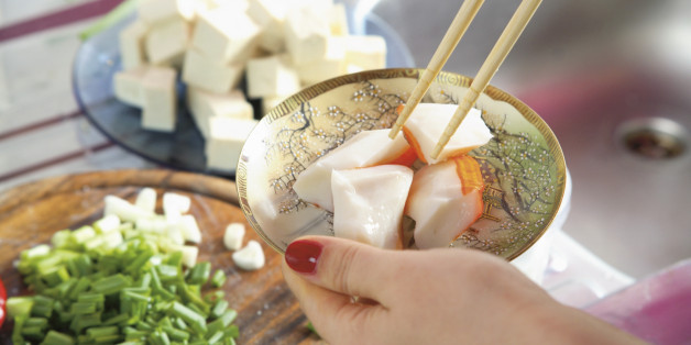 Woman?s hand holding plate of prepared food