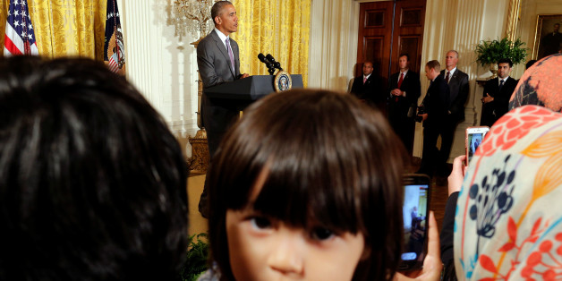 Sophia Ahmadinejad, 2-year-old, a refugee from Afghanistan listens as U.S. President Barack Obama delivers remarks at an Eid al-Fitr reception at the White House in Washington, U.S., July 21, 2016. REUTERS/Carlos Barria