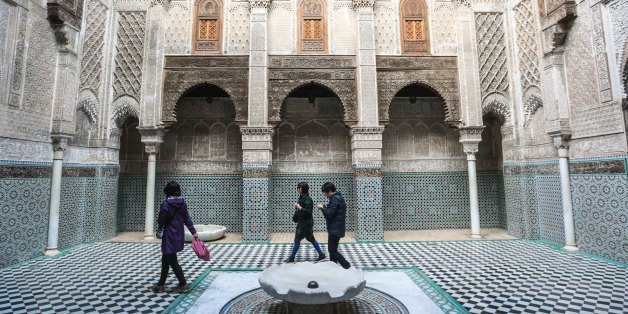Tourists visit Al-Attarine Madrasa, an historic religious school and mosque in Fez, Morocco, Sunday, Feb. 7, 2016. The madrasa takes its name from the Souk al-Attarine, the spice and perfume market. (AP Photo/Mosa'ab Elshamy)