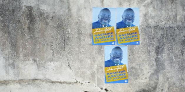 A man walks past election posters for Zacharie Myboto, one of the 23 declared presidential candidates for Sunday's poll, in the capital Libreville, August 22, 2009. The winner of Gabon's August 30 presidential election will have to tackle a stretched budget and an oil economy in long-term decline, but international partners are unlikely to see a shift from investor-friendly policies. None of the candidates standing to succeed Omar Bongo, who towered over the central west African state for four d
