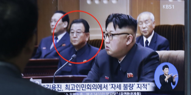 A man watches a TV screen showing a file image of Kim Yong Jin, second from left, a vice premier on education affairs in North Korea's cabinet, and North Korean leader Kim Jong Un, second from right, at the Seoul Railway Station in Seoul, South Korea, Wednesday, Aug. 31, 2016. North Korea has executed a vice premier and banished two other top officials to rural areas for re-education, South Korean officials said Wednesday. The letters read " North Korea has executed Kim Yong Jin". (AP Photo/Ahn