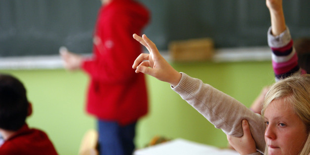 Students raise their hands to answer a question during their class in a Catholic school in Sarajevo, one of seven Catholic schools that have become islands of multiculturalism in the deeply divided society of Bosnia, October 16, 2009. Many children from mixed marriages, who have become a new minority in Bosnia's largely mono-ethnic towns and schools, feel better protected in mixed Catholic schools from the stigma of ethnic identity that mark out "different" students. Photo taken Octiber 16, 2009. To match Reuters Life! BOSNIA-CATHOLICS/SCHOOL REUTERS/Danilo Krstanovic (BOSNIA AND HERZEGOVINA EDUCATION SOCIETY RELIGION)