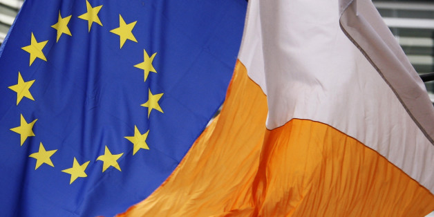An Irish flag flies next to an European Union flag in front of the EU Commission headquarters in Brussels June 13, 2008. Irish voters have rejected the European Union's Lisbon treaty, putting plans to overhaul the bloc's institutions in peril and humiliating Ireland's political leaders. REUTERS/Francois Lenoir (BELGIUM)