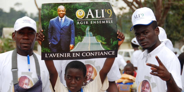 Supporters of Ali Bongo Ondimba, son of former dictator Omar Bongo, attend a campaign rally in Ntoum, outside Libreville, Gabon Sunday Aug. 23, 2009. The younger Bongo, 50, is running to replace his father, who ruled the central African nation for 41 years until his death in June, in presidential elections Sunday, Aug. 30. Poster reads: Top: "To Act Together" and bottom, "The Future in Confidence". (AP Photo/Joel Bouopda Tatou)