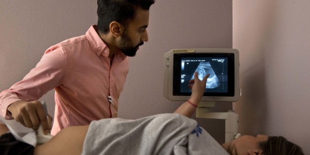 SOCIAL VALUES: Dr. Bhavik Kumar, 31, listens to a question from a patient considering abortion during her ultrasound at the Whole Woman's Health clinic in Fort Worth, Texas, on Friday, June 3, 2016. Women considering abortion are required by the state to have a sonogram that they must be offered the chance to view, although they can refuse to look. There is then a required 24-hour waiting period after the initial consultation. Some must now travel long distances twice in order to complete the pr