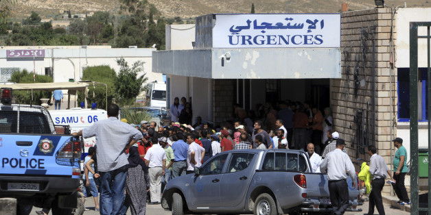 Residents gather outside the hospital of Kasserine, near the Algerian border, Thursday, July 17, 2014. Militants in western Tunisia staged two simultaneous attacks on army posts while soldiers held a Ramadan feast, killing at least 14 soldiers, authorities said Thursday. (AP Photo/ Mouldi Kraeim)