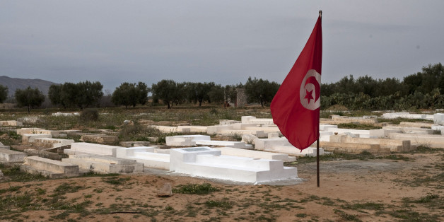 A Tunisian flag flies next to the grave of Mohamed Bouazizi, the local fruit vendor who set himself on fire Dec. 17, on the outskirts of the town of Sidi Bouzid, Tunisia, Wednesday, March 9, 2011. The desperate act set off mass protests that brought down Tunisian President Zine El Abidine Ben Ali in less than a month and inspired others who toppled autocratic Egyptian President Hosni Mubarak, launched an armed rebellion against Libyan despot Moammar Gadhafi, and rattled governments in Yemen, Bahrain and elsewhere. (AP Photo/Giorgos Moutafis)