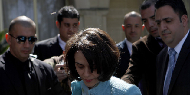 Delia Velculescu, head of Troika (IMF), leaves the presidential palace after meeting with Cyprus' President Nicos Anastasiades, not pictured, in the capital Nicosia, Wednesday, March 20, 2013. Cypriot lawmakers on Tuesday rejected a critical draft bill that would have seized part of people's bank deposits in order to qualify for a vital international bailout, with not a single vote in favor. (AP Photo/Petros Karadjias)