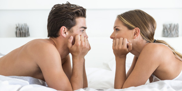 Couple lying face to face on the bed