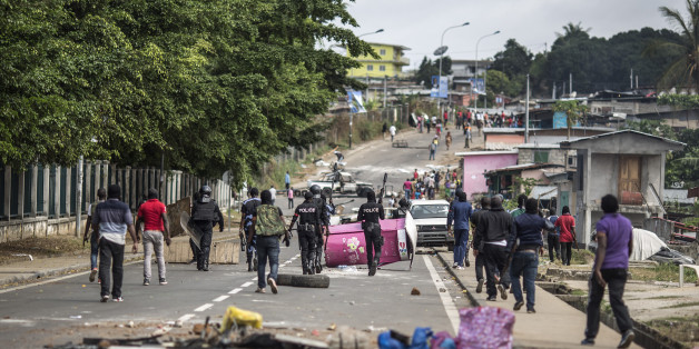 Gabonese police forces are seen clearing barricades in the streets adjacent to the National Assembly in Libreville on September 1, 2016.