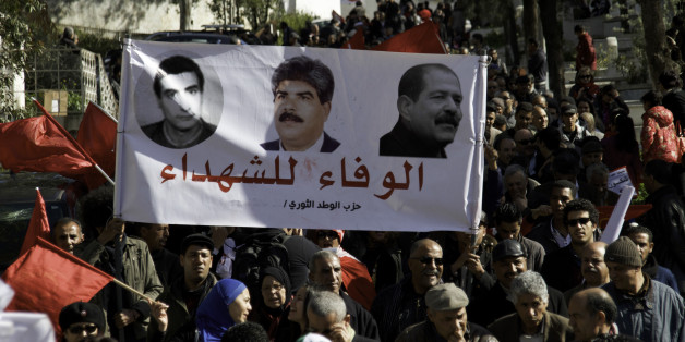 Banner of the Popular Front Martyrs Left Fadhel Sassi center Mohamed Brahmi and left Chokri Belaid. On the occasion of the commemoration of the first anniversary of the assassination of Chokri Belaid, thousands of people gathered at his grave at Al Jalez cemetery in Tunis Tunisia February 8th 2014. (Photo by Mohamed Krit/NurPhoto) (Photo by NurPhoto/Corbis via Getty Images)