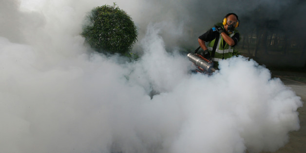 A worker fogs the common areas of a public housing estate at an area where locally transmitted Zika cases were discovered in Singapore August 31, 2016. REUTERS/Edgar Su TPX IMAGES OF THE DAY