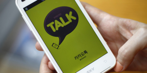 In this Aug. 20, 2012 photo, a woman opens Kakao Talk, a South Korean mobile messaging app with more than 60 million users, on her smartphone in Seoul, South Korea. A handful of smartphone apps that began as basic instant messaging services have amassed several hundred million users in Asia in just a couple of years, mounting a challenge to the popularity of online hangouts such as Facebook as they branch into games, e-commerce, celebrity news and other areas. (AP Photo/Hye Soo Nah)