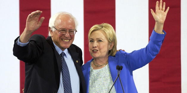 Democratic presidential candidate Hillary Clinton waves to supporters with Sen. Bernie Sanders, I-Vt., during a rally in Portsmouth, N.H., Tuesday, July 12, 2016, where Sanders endorsed her for president. (AP Photo/Jim Cole)