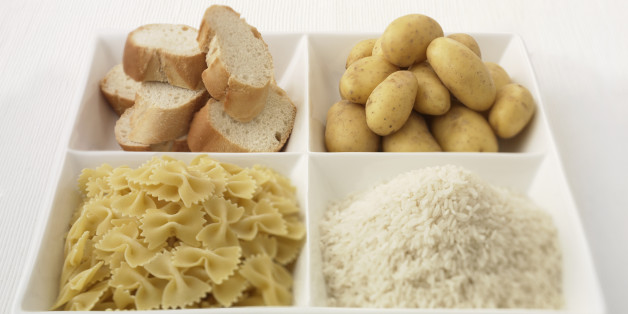 Close up of sectioned plate with bread, potatoes, rice and pasta