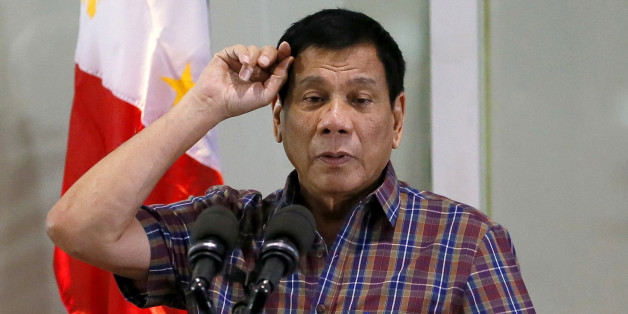 FILE - In this Aug. 31, 2016, file photo, Philippine President Rodrigo Duterte gestures as he addresses Overseas Filipino Workers who were repatriated back to the country at the Ninoy Aquino International Airport in Pasay city, south of Manila, Philippines. Duterte, who disparaged the pope and others who controvert his worldview, warns U.S. President Barack Obama on Monday, Sept. 5, 2016, not to question him about extrajudicial killings. (AP Photo/Bullit Marquez, File)