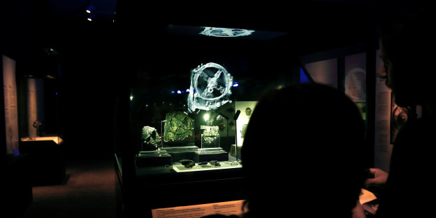 Visitors look at the displayed fragments of the ancient Antikythera Mechanism at the National Archaeological Museum in Athens, Greece June 9, 2016. REUTERS/Alkis Konstantinidis