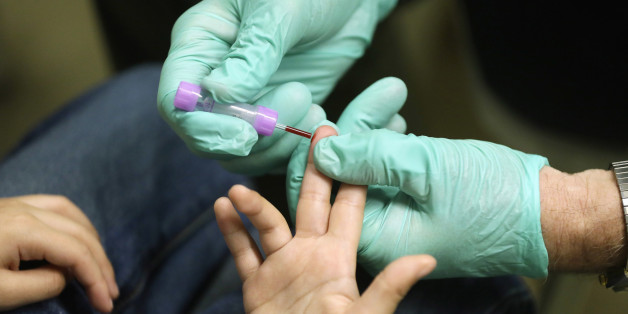 FILE - In this Jan. 26, 2016 file photo, registered nurse Brian Jones draws a blood sample from a student at Eisenhower Elementary School in Flint, Mich. The students were being tested for lead after the metal was found in the city's drinking water. Blood-lead levels in Flint children under the age of 6 were significantly higher after the city switched its water in 2014 in a cost-saving move, according to report released Friday, June 24, 2016, by U.S. disease experts. (AP Photo/Carlos Osorio, Fi