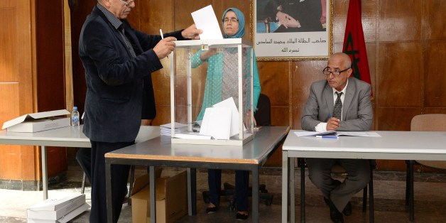 A Moroccan man casts his vote at a polling station in the capital Rabat on October 2, 2015, during an indirect vote to elect Morocco's upper chamber of parliament. The portrait on the wall shows Moroccan King Mohammed VI. AFP PHOTO / FADEL SENNA (Photo credit should read FADEL SENNA/AFP/Getty Images)