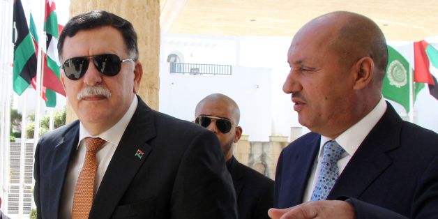 Libyan Prime Minister Fayez al-Sarraj (L) arrives for the second day of UN-brokered talks with members of the Libyan Political Dialogue to discuss power struggles and jihadist threats that are undermining stability in the oil-rich country on September 6, 2016 in Tunis. / AFP / STRINGER (Photo credit should read STRINGER/AFP/Getty Images)