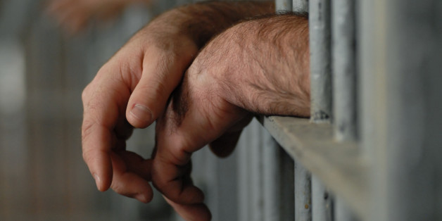 man behind bars or in jail