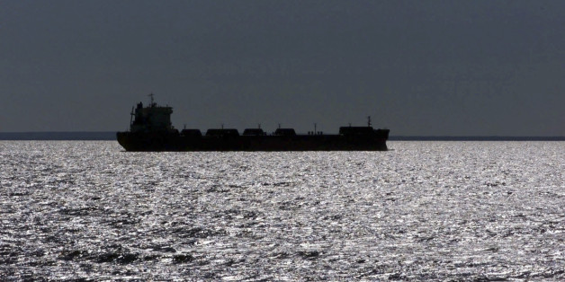 FILE -- In this July of 1999 file photo, a freighter is silhouetted in Lake Superior near Whitefish Point, Mich. A plan gaining support in Congress and backed by the cargo shipping industry would establish a nationwide policy for treating ballast water dumped from cargo ships into U.S. waterways. Environmental groups say that would open the door to more invasive species like zebra and quagga mussels, which have wreaked havoc from the Great Lakes to the West Coast. (AP Photo/Carlos Osorio)